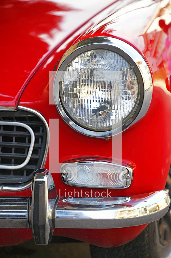 Headlight on red car