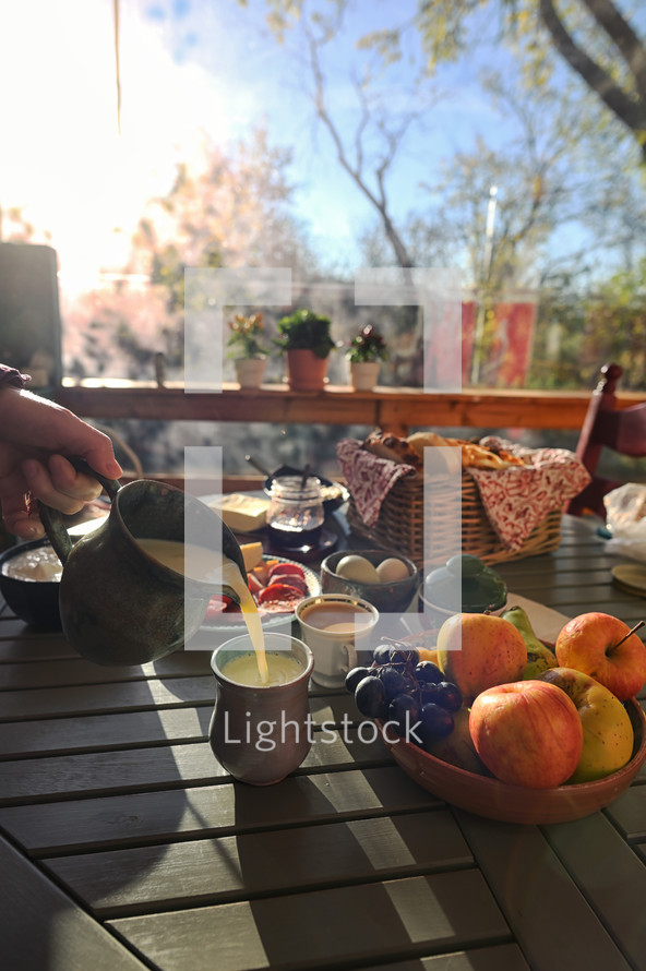 Pouring juice and having breakfast outside 