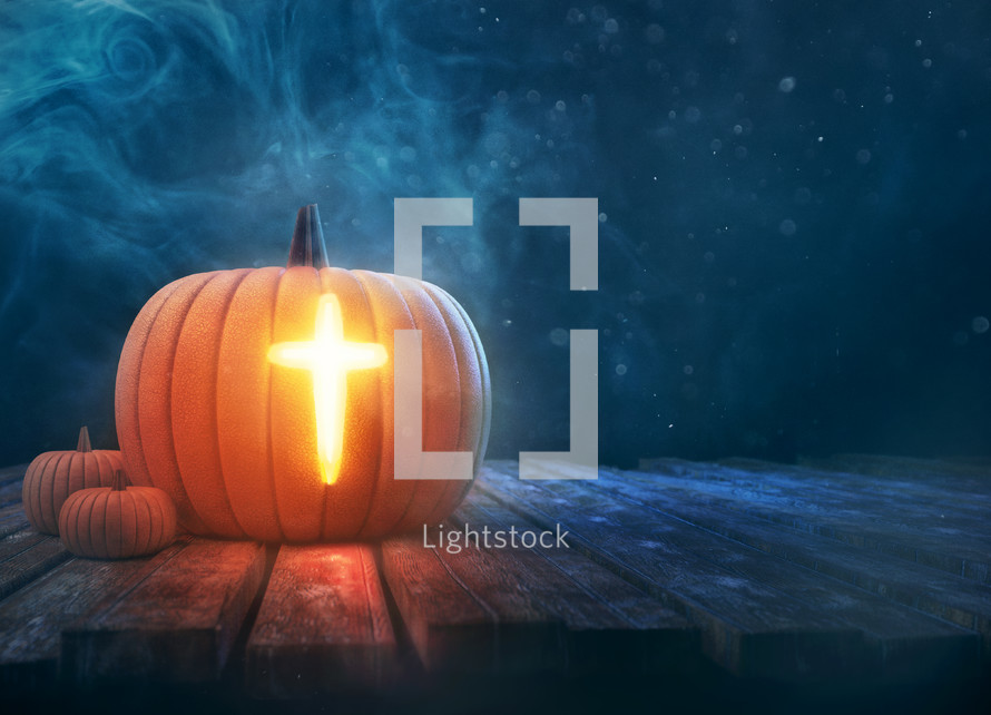 A single pumpkin with a glowing cross shining brightly.