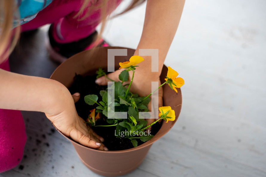 girl planting flowers 