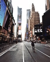 man riding a bicycle through Times Square 