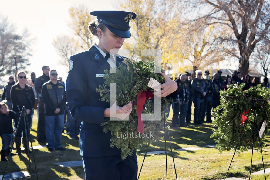 Solider with a wreath in a cemetery 