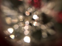 Red and white bokeh lights with a hint of a snowflake shape