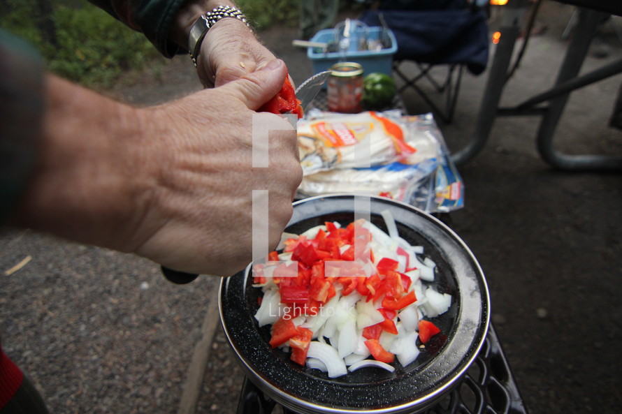 cutting vegetables to cook while camping 