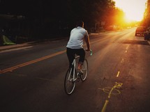 man riding a bike on a road 