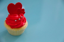 Valentine's day cupcake with frosting and red hearts