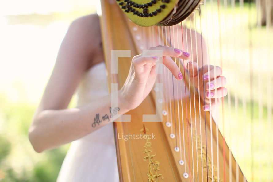 a woman playing a harp at a wedding 