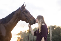 a woman kissing a horse 