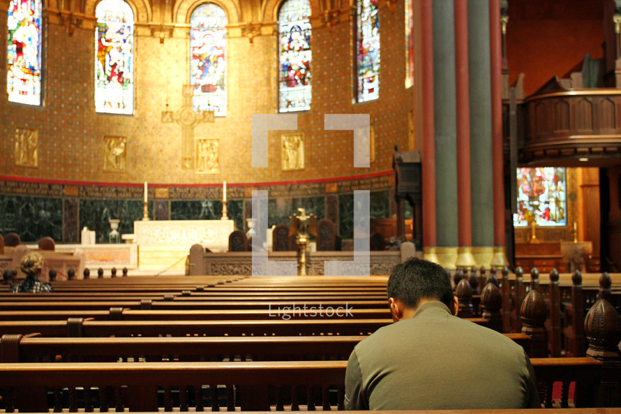 Man praying in beautiful old church