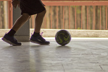 A boy kicking a soccer ball