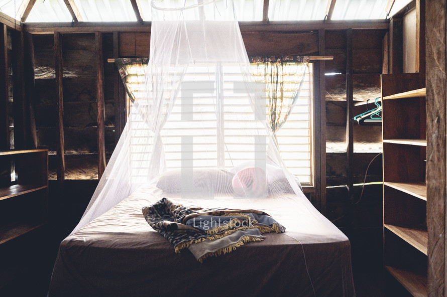 cabin and bed with mosquito net in Honduras 