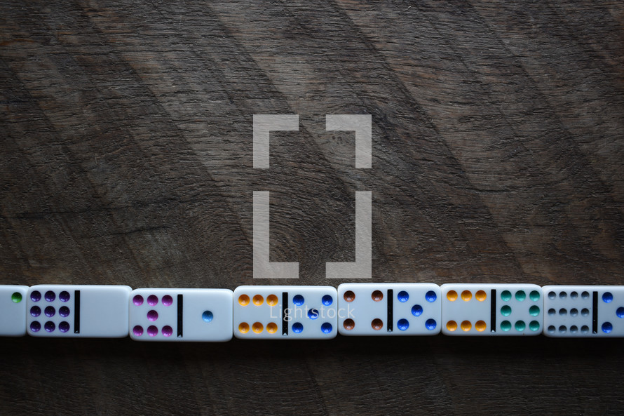 dominoes against a wood background 