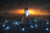 a toddler girl holding a lightbulb 