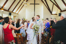 bride and groom kissing in the aisle 