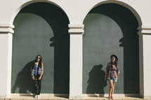 young women posing in front of a building 