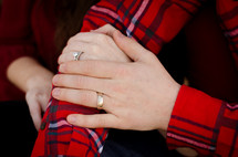 a couple showing off their wedding rings 