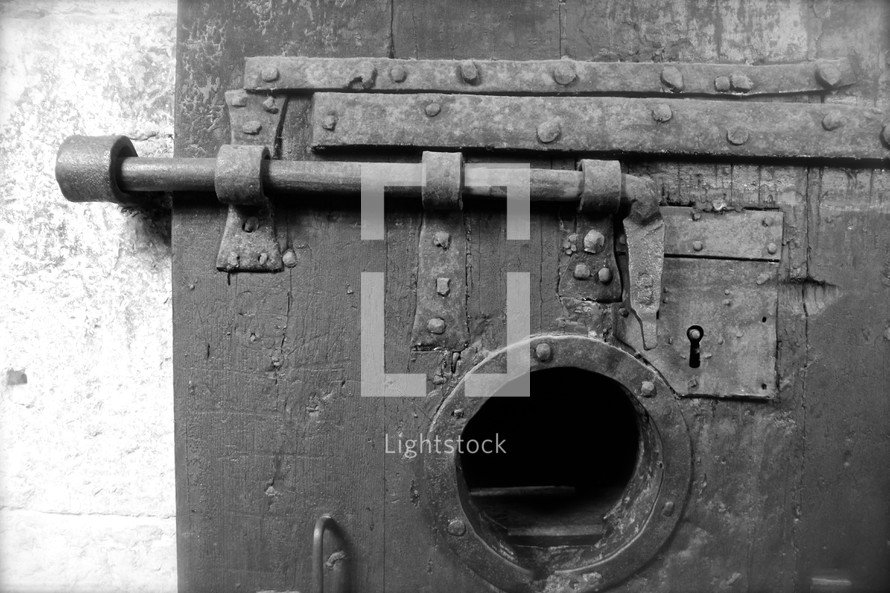 ancient prison door with bolt window and lock
