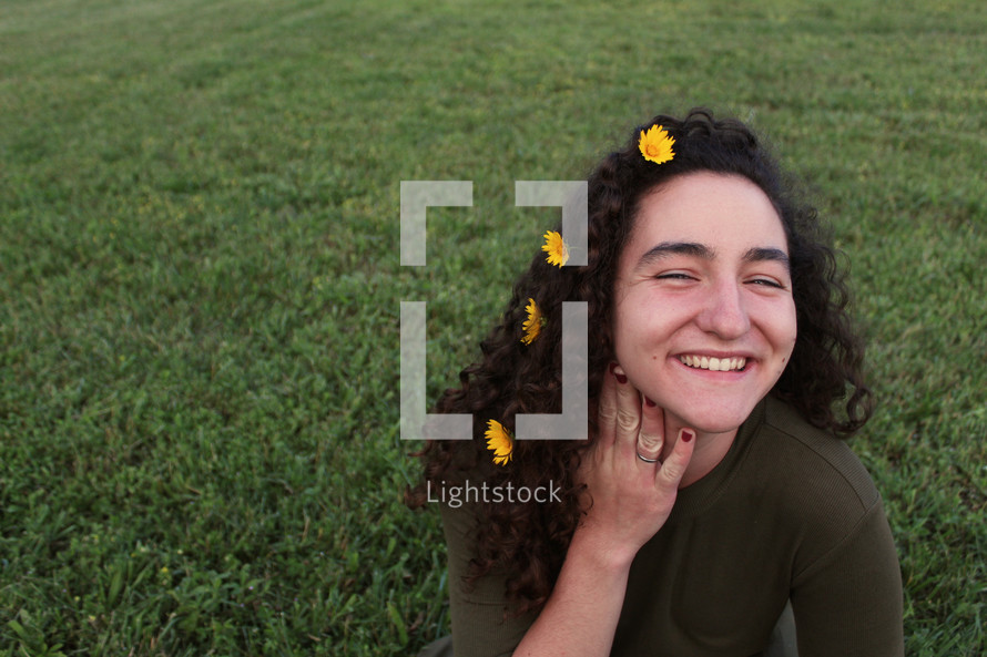 smiling woman with flowers in her hair 