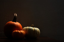 three pumpkins in shadows 