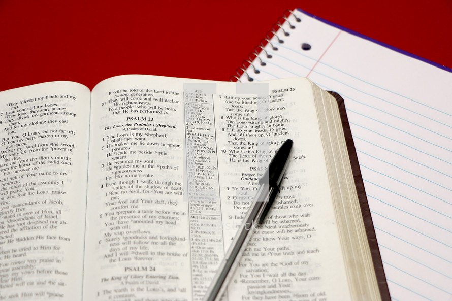 a Bible opened to Psalm 23 and a pen 