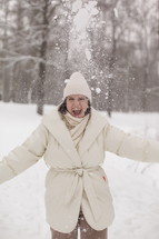 a woman throwing snowballs 