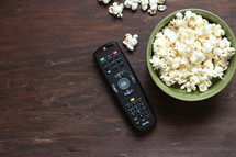 remote control and bowl of popcorn 