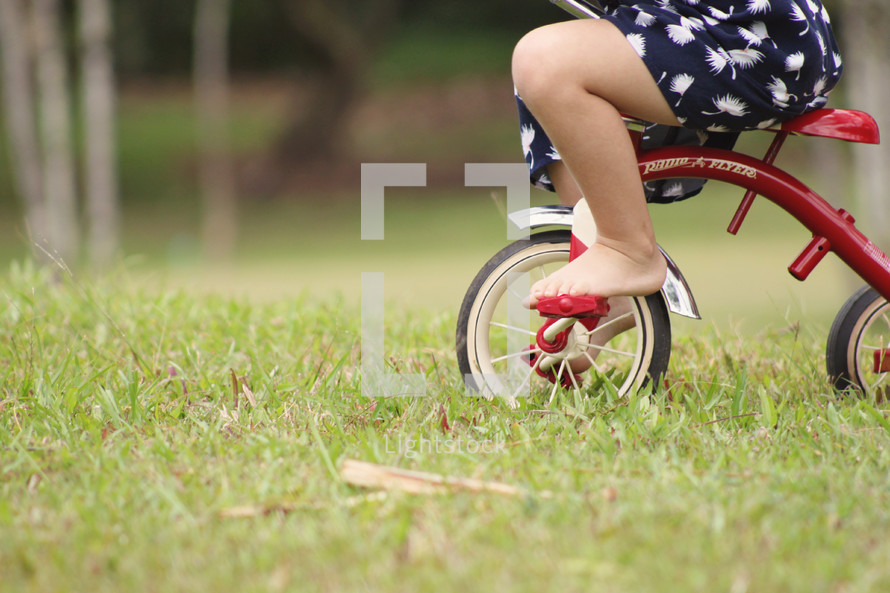 child riding a tricycle 