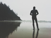 silhouette of a man standing at the beach