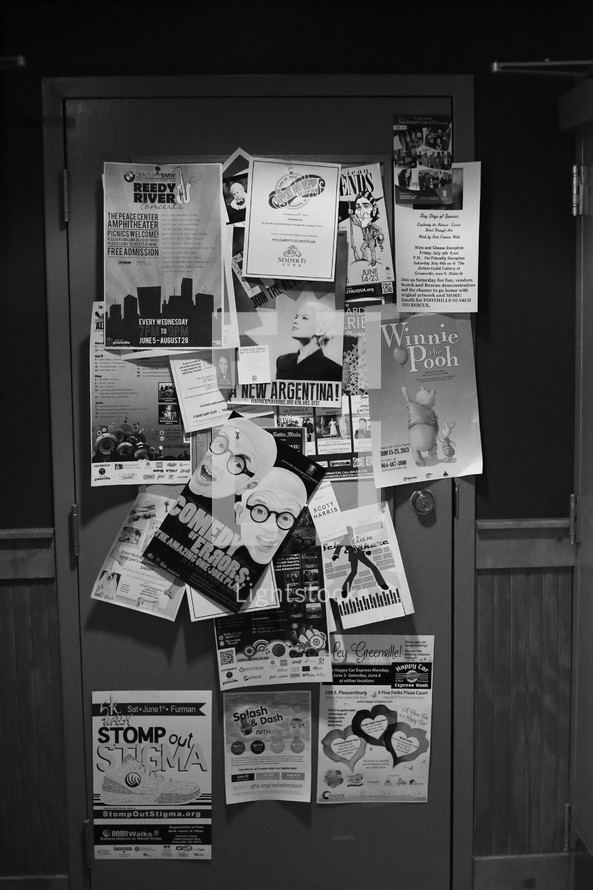 Theatre flyers tacked all over a door.