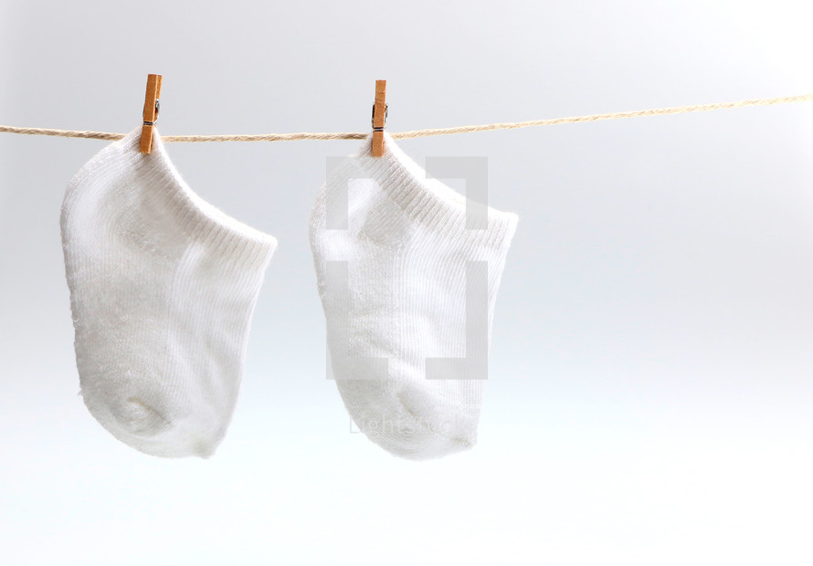baby socks drying on a clothesline 