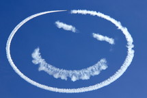 Sky writing a happy face in the cobalt blue sky