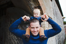 father with infant son on his shoulders 