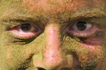 Man's eyes through dirt on his face