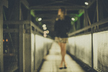 blurry image of a woman standing in a tunnel 