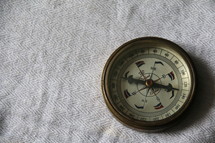 Hand held antique brass compass measuring direction and orientation
