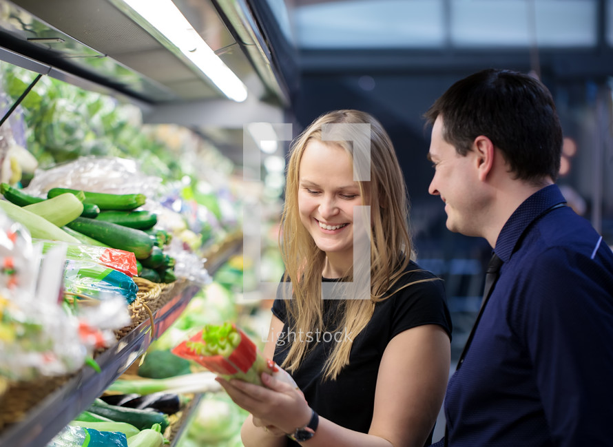Man and woman shopping for vegetables