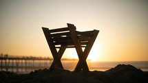 manger on a beach at sunset 