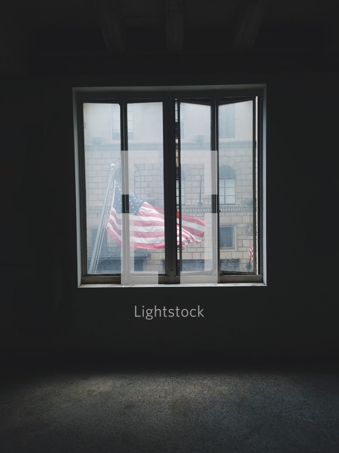 view of an American flag flying through a window 