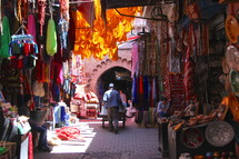 Man pushing a cart through a Souk or Arab World market in North Africa