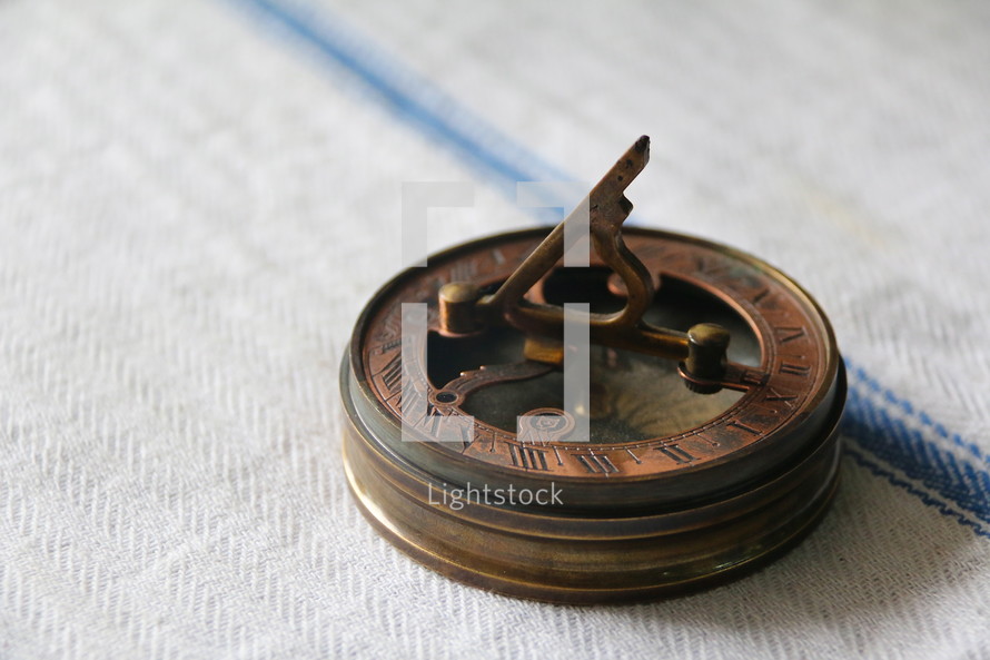 Antique pocket brass compass and sun dial to measure direction, orientation and time