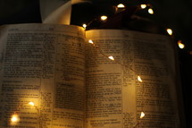 fairy lights on the pages of a Bible 