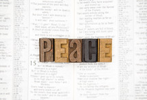 word peace on the pages of a Bible 