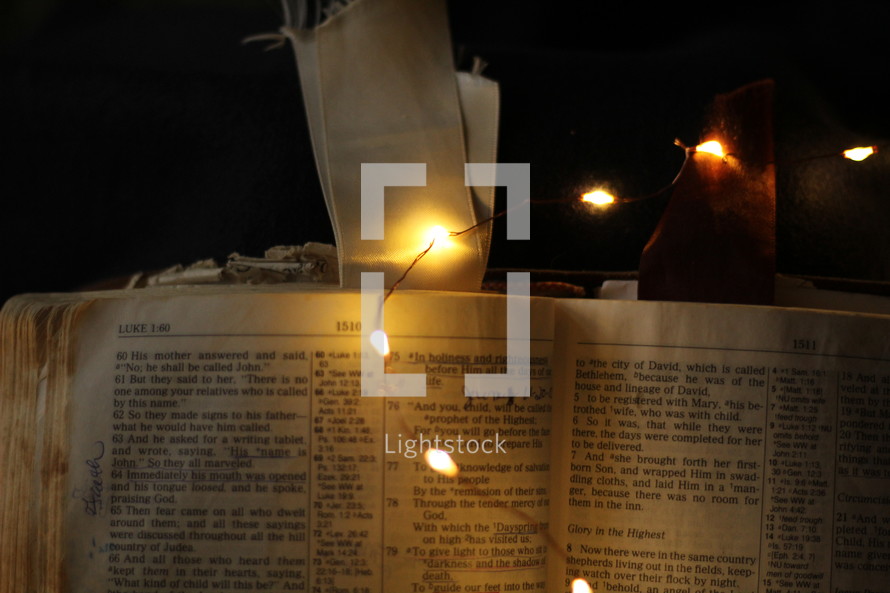 fairy lights on the pages of a Bible 