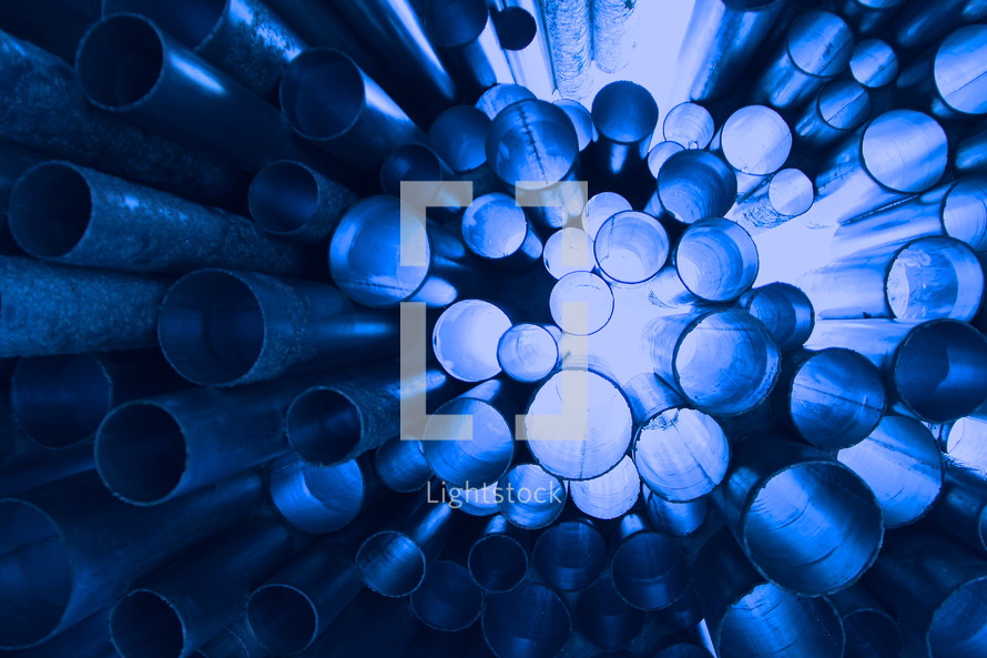 Suspended pipes, with light shining through, abstract background 