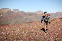 a man hiking on a rugged landscape 