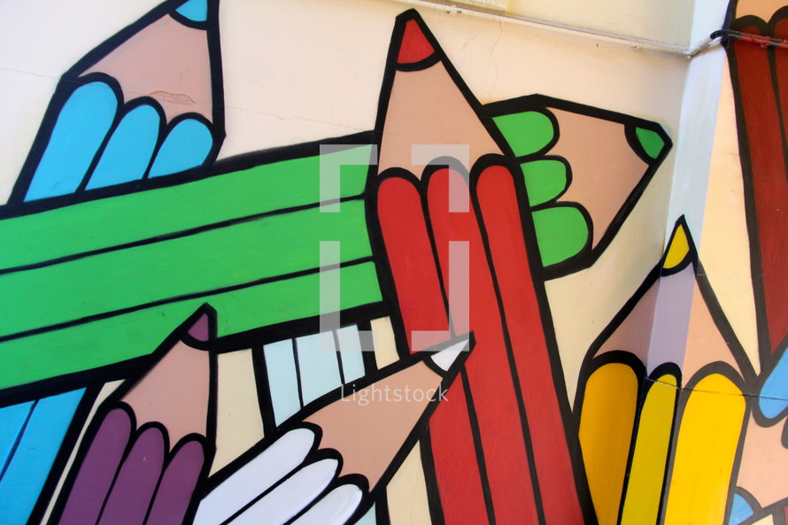 Painted mural of children's rainbow coloring crayons