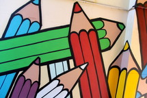 Painted mural of children's rainbow coloring crayons