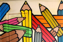Painted mural of children's rainbow color crayons