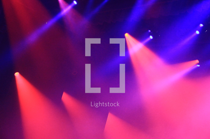 spot lights illuminate the stage at a youth concert