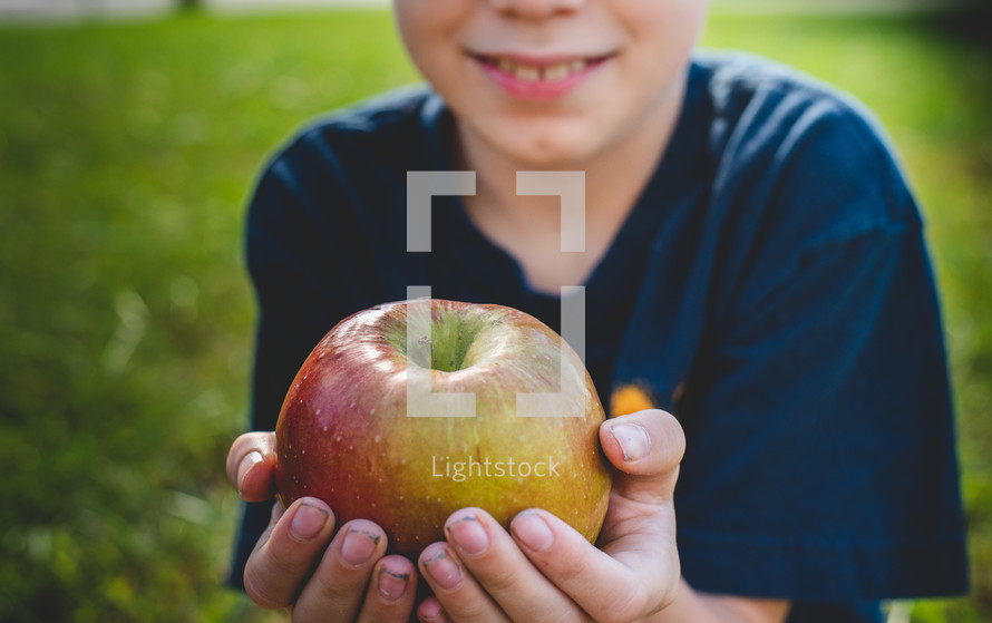 a child holding an apple 